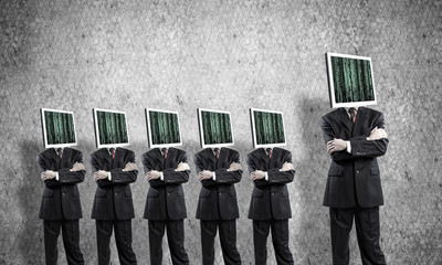 Businessmen with monitors instead of head.