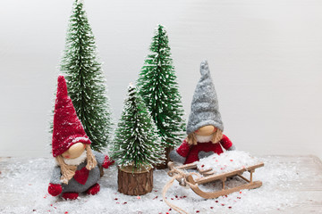 Christmas festive card with gnome,fir tree,sledge and snow.