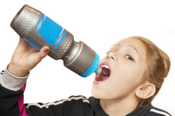 A good girl drinks water from a sports water bottle after the workout