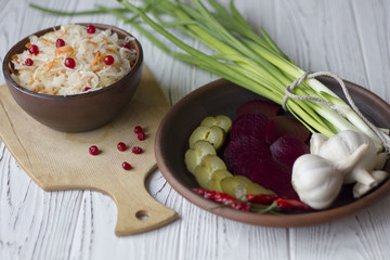 Traditional Russian pickled cucumbers, onions, beets, chili, garlic, sauerkraut with cranberries on the table