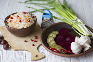 Traditional Russian pickled cucumbers, onions, beets, chili, garlic, sauerkraut with cranberries on the table
