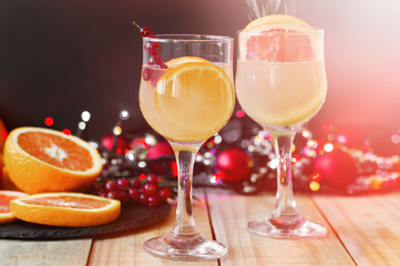 Party drinks. Cocktails with orange, grapefruit and red currant served with citrus fruits and christmas decoration