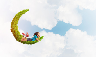 Concept of careless happy childhood with girl dreaming about something