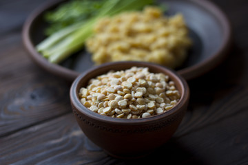 pea porridge, peas and onions in a clay pot on a wooden table