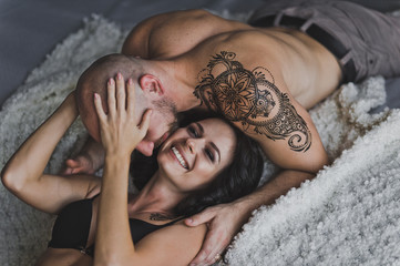 Happy young couple in underwear having fun in bed 183.