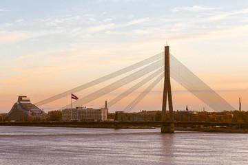 the bridge in the city of Riga against the background of a sunset.