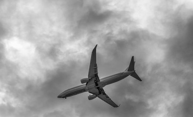 Airplane silhouette against overcast sky