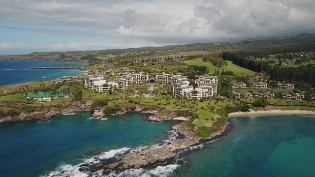 Fly over Pacific Ocean and comfortable Hawaiian resort and picturesque terrain