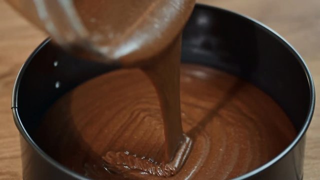 Pouring cake mix into baking tin