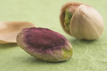 Obraz na płótnie Canvas Sicilian pistachio on green background