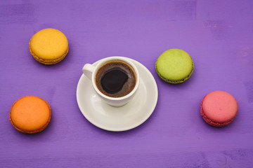 coffee and macaroons on a lavender background
