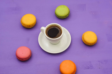 coffee and macaroons on a lavender background