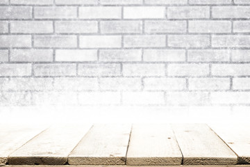 Wooden table on white wall and snow Christmas winter background.