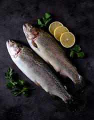 Organic raw fresh trout fish on an old wooden background. Top view. 
