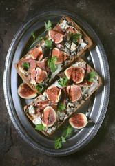 Sandwich of chiabaha, soft cheese, blue cheese, ham parma, figs and balsamic cream. Top view.