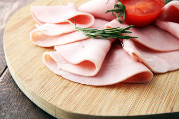 Sliced ham on wooden background. Fresh prosciutto. Pork ham sliced