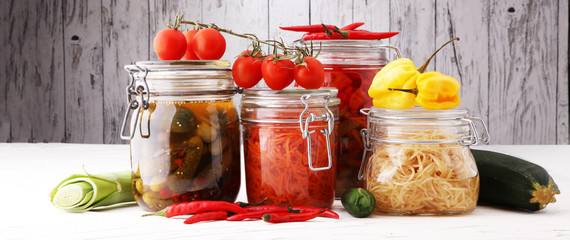 Jars with variety of pickled vegetables. Preserved food.