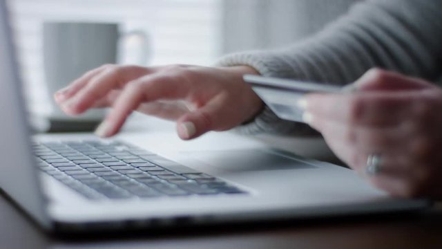 Closeup Of Woman's Hands, As She Uses Her Laptop To Online Shop Or Pay Bills From Home