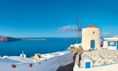 Traditional windmill and apartments in Oia village, Santorini, Greece