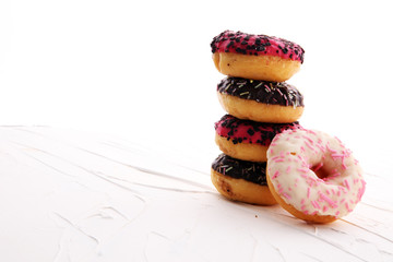 assorted donuts with chocolate frosted, pink glazed and sprinkles donuts