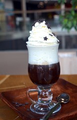 Viennese coffee with whipped cream on glass cup.