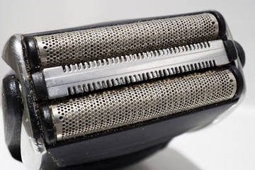 Dirty electric shaver or razor in the bath.