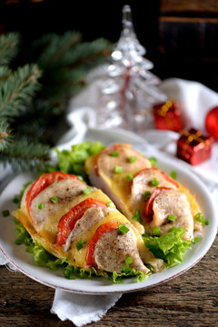 Baked chicken breast with tomato and cheese.