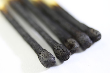 Five burning matches close-up.