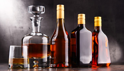 Carafe and bottles of assorted alcoholic beverages.