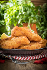 Fried cod slices in breadcrumbs.