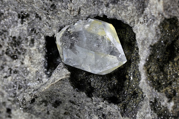 Herkimer diamond nestled in bedrock isolated on white background