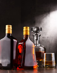Obraz na płótnie Canvas Carafe and bottles of assorted alcoholic beverages.