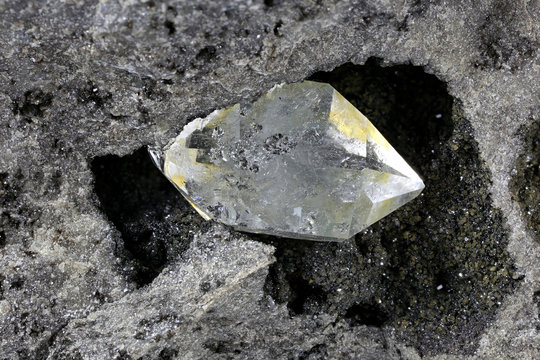 Herkimer diamond nestled in bedrock isolated on white background
