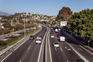 Highway asphalt two way road with cars and trucks. Tropics