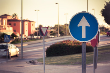 Mandatory sign road sign, Forward in the city. Street warning sign at background
