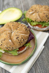 Sandwiches with avocado, camembert, vegetable salad and salami. Breakfast on the rustic table.