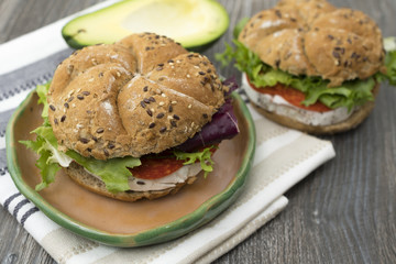 Sandwiches with avocado, camembert, vegetable salad and salami. Breakfast on the rustic table.