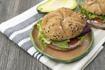 Sandwiches with avocado, camembert, vegetable salad and salami. Breakfast on the rustic table.