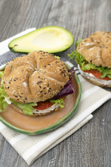 Sandwiches with avocado, camembert, vegetable salad and salami. Breakfast on the rustic table.