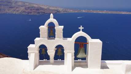 santorini blue sky sea white walls bells island