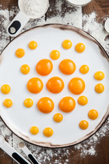 Raw egg yolks on white plate