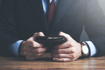 businessman hand wallet on table
