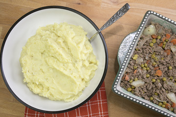 Food preparation of Shepherd's Pie made with ground beed, vegetables and mashed potatoes