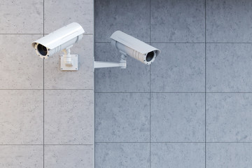 White cameras on a gray wall