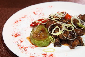 Fried beef liver with mushrooms, vegetables and spices.