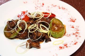 Fried beef liver with mushrooms, vegetables and spices.