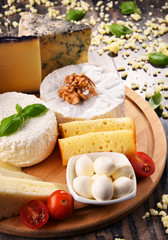 Different sorts of cheese on kitchen table