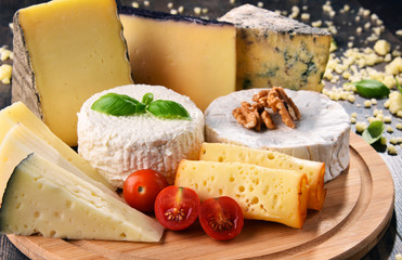 Different sorts of cheese on kitchen table