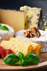 Different sorts of cheese on kitchen table