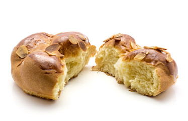 Broken braided bread isolated on white background two halves.